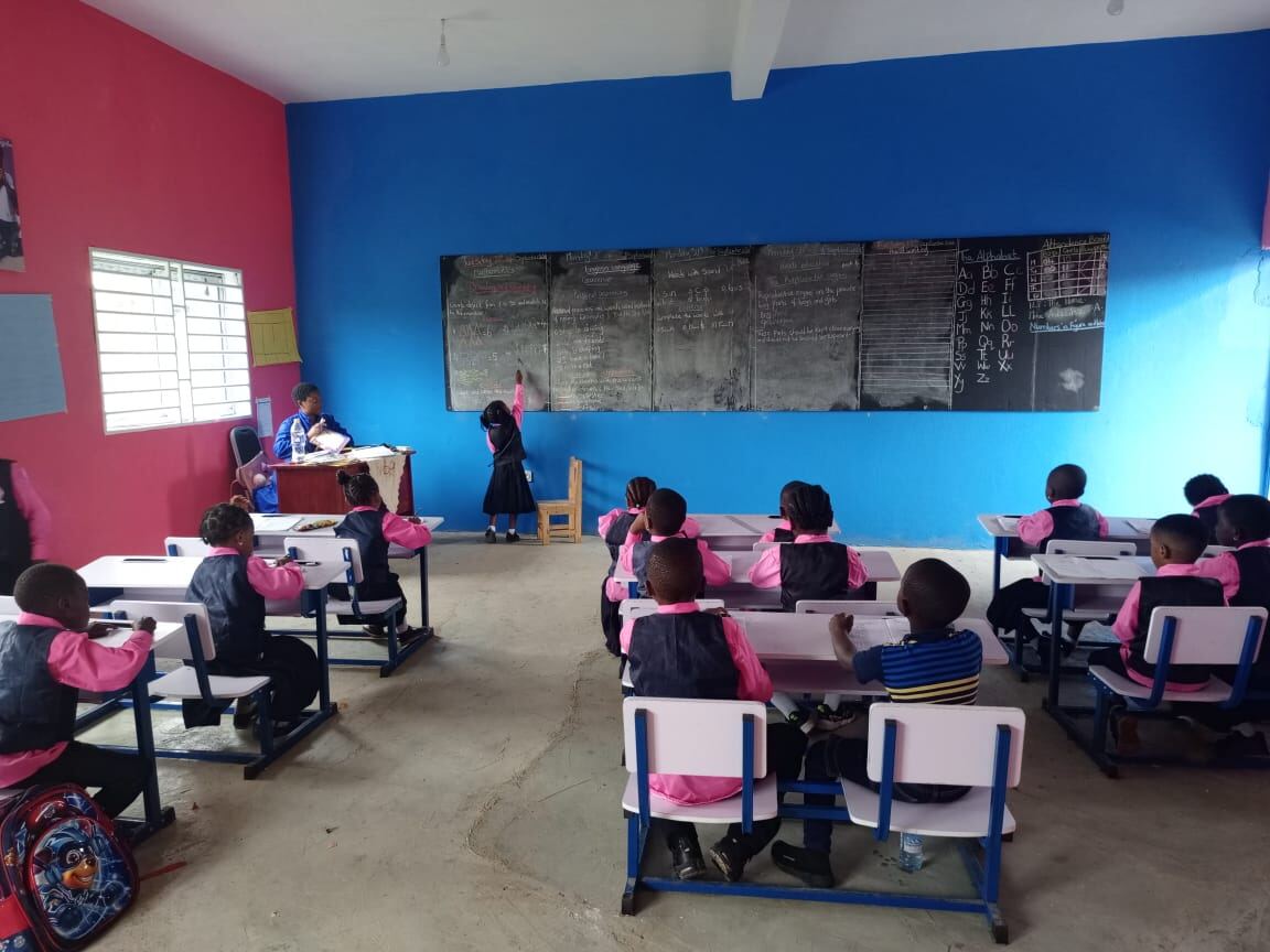 Teacher and pupil at the blackboard during a lesson
