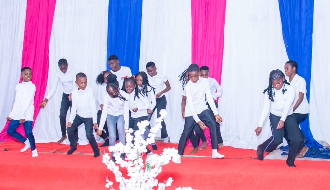 Pupils performing a dance on stage at the graduation ceremony