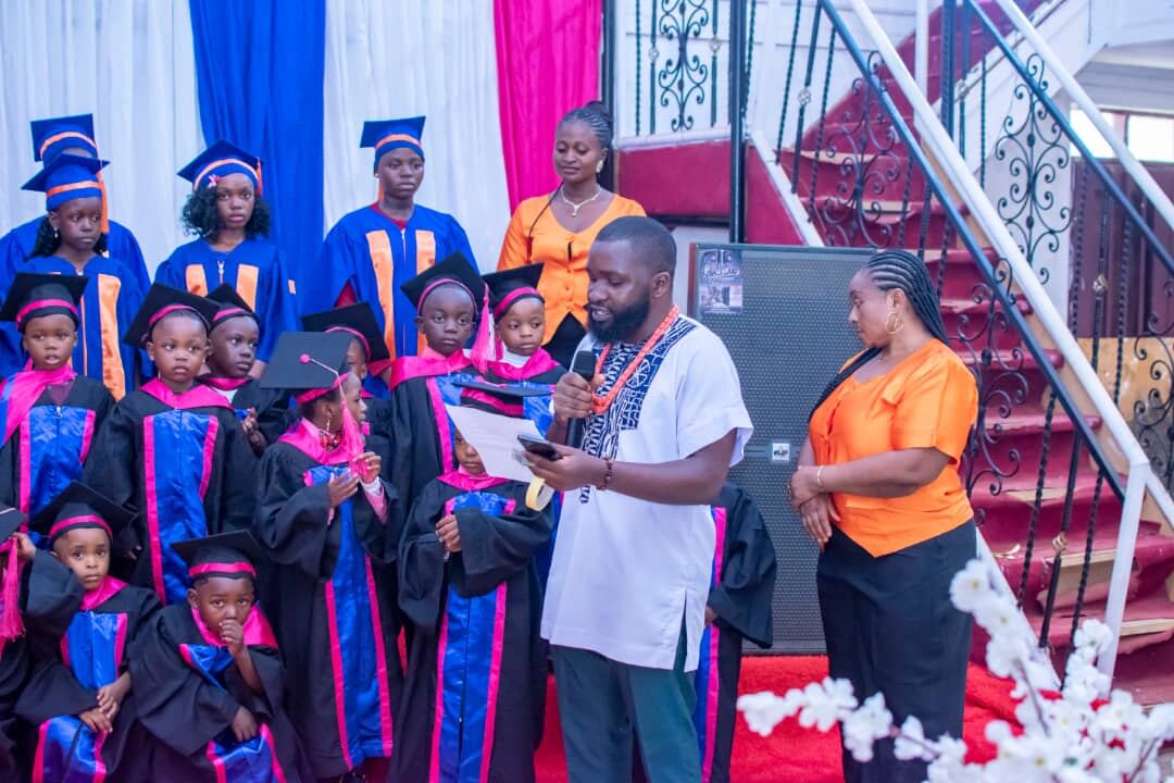 Event host addressing graduating pupils on stage