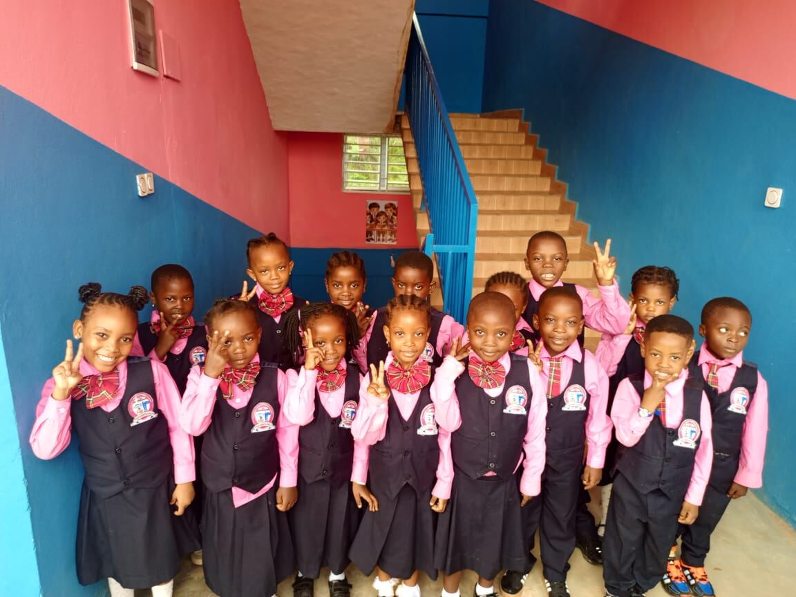 Pupils in school uniform posing together
