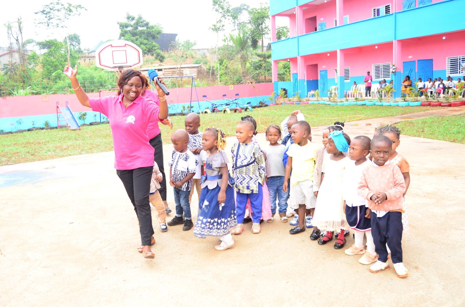 Pupils lined up on the playground with a staff member